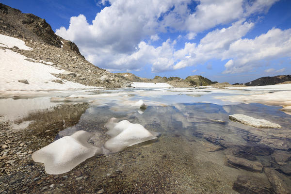 Ice and snow during summer thaw of the alpine lake Joriseen Jörifless Pass canton of Graubünden Engadin Switzerland Europe
