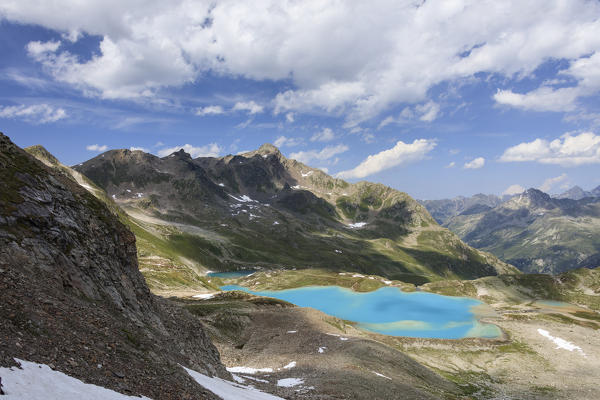Clouds and sun on turquoise lakes framed by rocky peaks Joriseen Jörifless Pass canton of Graubünden Engadin Switzerland Europe