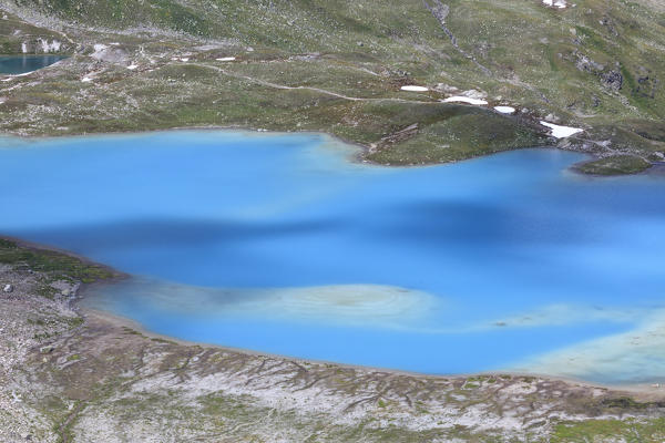 Summer view of the turquoise alpine lake framed by rocks Joriseen Jörifless Pass canton of Graubünden Engadin Switzerland Europe