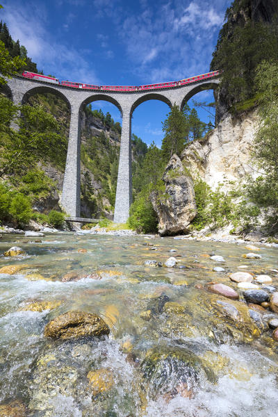 The alpine stream frames the Bernina Express train on Landwasser Viadukt Filisur Albula Valley Canton of Graubünden Switzerland Europe