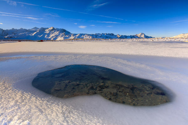 Blue sky on the alpine Lake Piz Umbrail surrounded by snowy peaks Braulio Valley Valtellina Lombardy Italy Europe