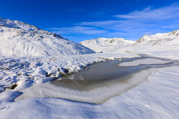 Blue sky on the alpine Lake Piz Umbrail surrounded by snowy peaks Braulio Valley Valtellina Lombardy Italy Europe