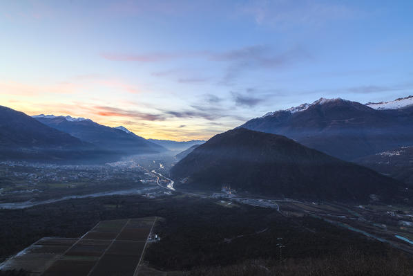 Sunset lights frame the mountains and cultivated fields Campo Tartano province of Sondrio Valtellina Lombardy italy Europe