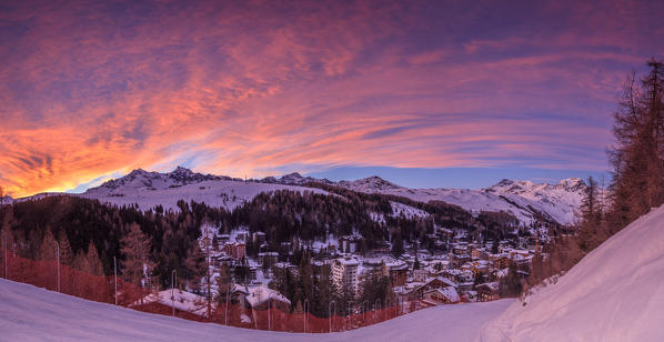 Panorama of the alpine village of Madesimo and snowy ski slopes at sunset Spluga Valley Valtellina Lombardy italy Europe