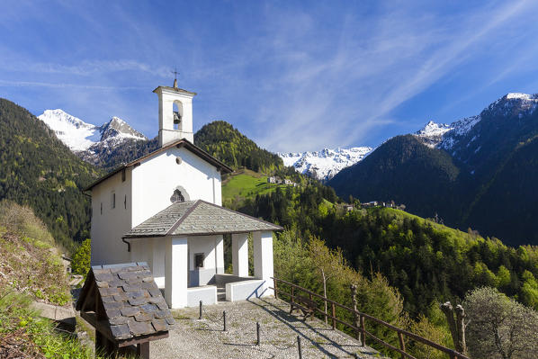 Church Madonna Delle Grazie framed by green woods and snowy peaks Via Priula Albaredo Valley Orobie Alps Lombardy Italy Europe