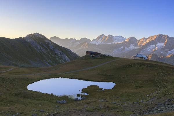 Meadows and lake around Cima Presanella seen from Monte Tonale Valcamonica border Lombardy and Trentino Alto Adige Italy Europe