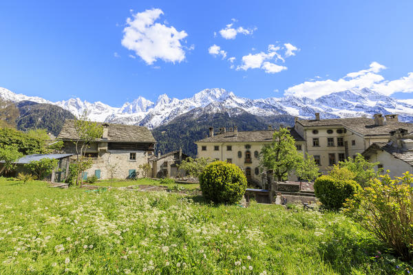 View of Soglio between meadows and snowy peaks in spring Maloja canton of Graubunden Engadin Bregaglia Valley Switzerland Europe