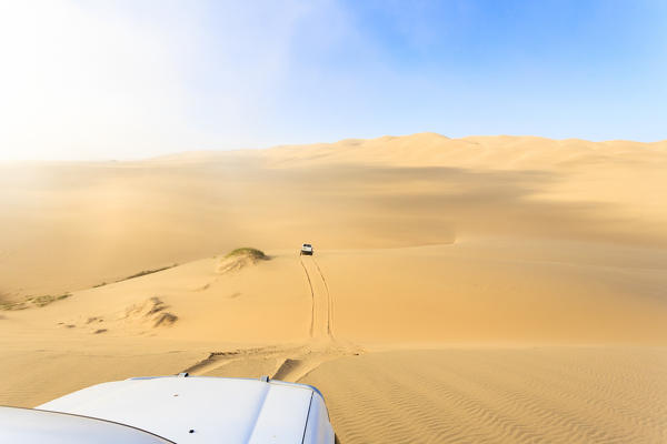 Jeep on the sand dunes modeled by wind Walvis Bay Namib Desert Erongo Region Namibia Southern Africa