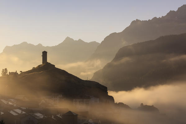 Tower of Steinsberg Castle shrouded by mist, Ardez, canton of Graubünden, district of Inn, lower Engadine, Switzerland, Europe