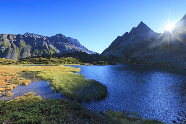 Sun rays on blue lake, Crap Alv Laiets, Chamonix,  canton of Graubünden, Engadin Valley, Switzerland