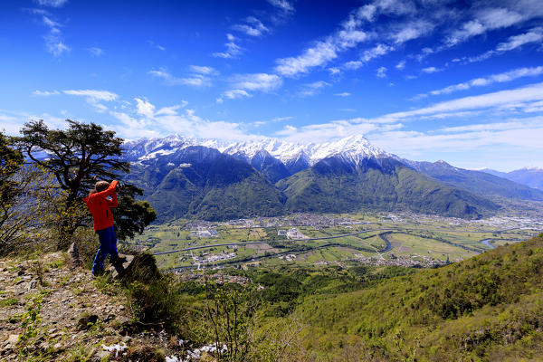Photographer admires the Rhaetian Alps from Prati Nestrelli, Civo, province of Sondrio, Valtellina, Lombardy, Italy, Europe