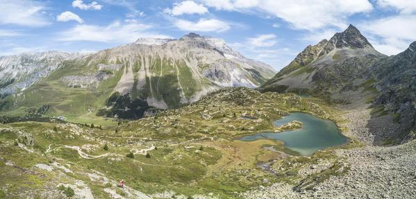 Panoramic of turquoise lake and rocky peaks, Crap Alv Lejets, Albula Pass, canton of Graubünden, Switzerland