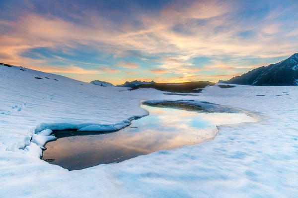 Lake Scermendone reflecting the sunset lights in its still water Valtellina, Sondrio, Lombardy, Italy Europe