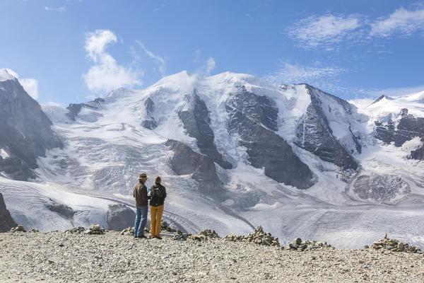 Tourists admire the Diavolezza and Pers glaciers and Piz Palù covered with snow, Engadine, canton of Graubünden, Switzerland