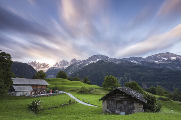 Sunrise above green meadows of Soglio, Bregaglia Valley,  Maloja Region, Canton of Graubunden, Switzerland