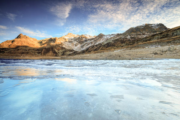 Frozen lake Montespluga at dawn, Chiavenna Valley, Sondrio province, Valtellina, Lombardy, Italy