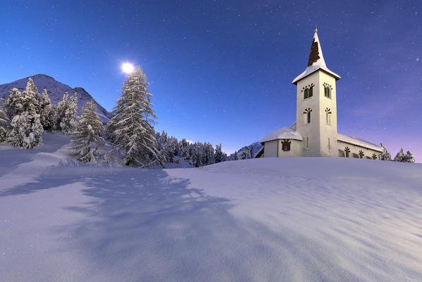 Moonlight on Chiesa Bianca surrounded by snow, Maloja, Bregaglia Valley, Canton of Graubunden, Engadin, Switzerland