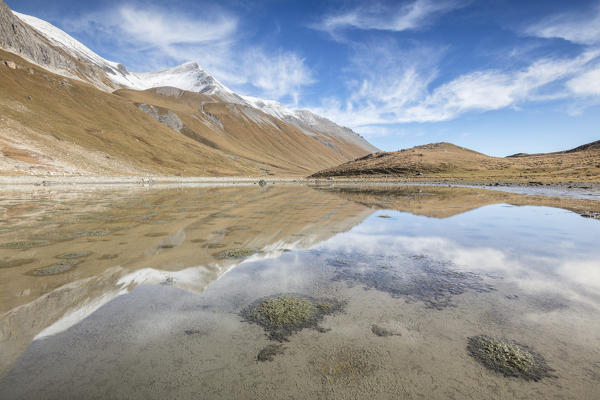 Mountain peaks reflected in water, Albula Pass, Bergün, Canton of Graubünden, Engadine, Switzerland