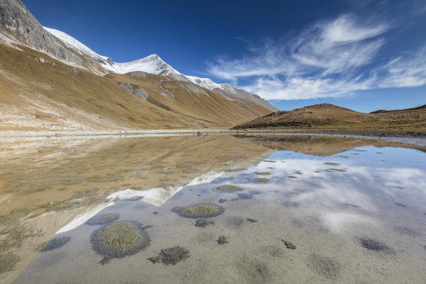 Mountain peaks reflected in water, Albula Pass, Bergün, Canton of Graubünden, Engadine, Switzerland