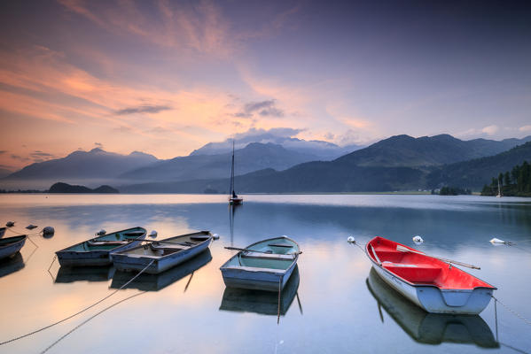 Boats moored in Lake Sils at sunrise, Plaun da Lej, canton of Graubunden, Engadine. Switzerland