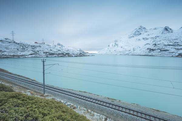 Railway on the shore of Lago Bianco, Bernina Pass, canton of Graubunden, Engadine, Switzerland