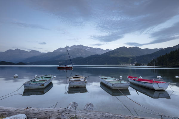 Boats moored in Lake Sils at dusk, Plaun da Lej, canton of Graubunden, Engadine. Switzerland