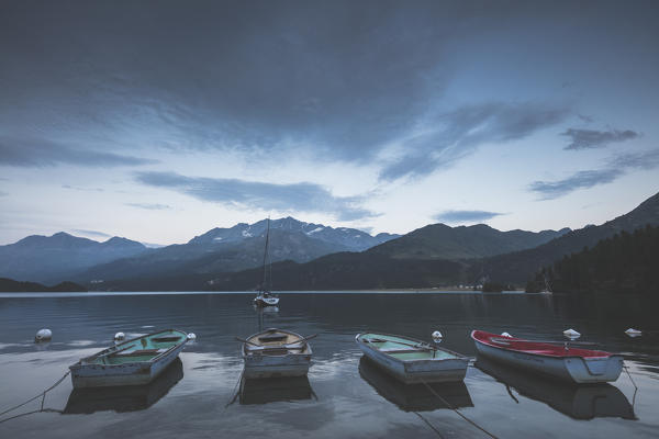 Boats moored in Lake Sils at dusk, Plaun da Lej, canton of Graubunden, Engadine. Switzerland