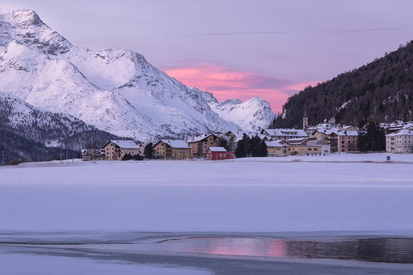 Village of Silvaplana and Piz Da La Margna seen from icy Lake Champfer, St.Moritz, canton of Graubunden, Engadin, Switzerland