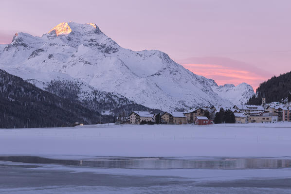 Village of Silvaplana and Piz Da La Margna seen from icy Lake Champfer, canton of Graubunden, Engadin, Switzerland