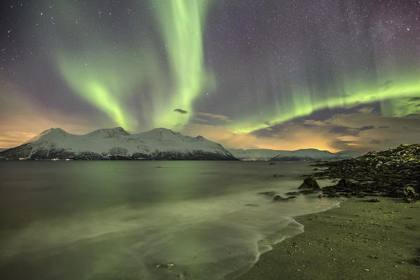 Northern Lights on the icy landscape of Svensby Lyngen Alps Tromsø Lapland Norway Europe