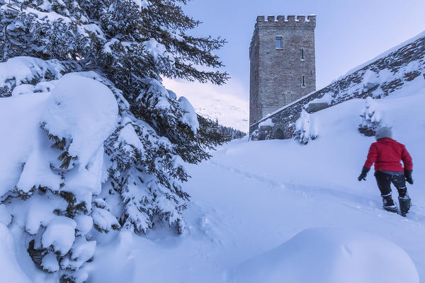 Woman on snowy path at Belvedere Tower, Maloja Pass, Bregaglia Valley, canton of Graubunden, Engadin, Switzerland