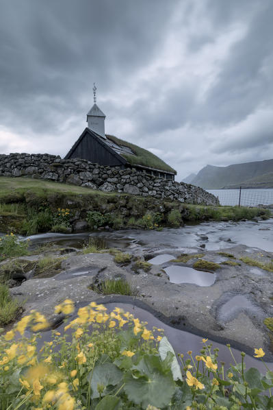 Cloudy sky on the historic church in Funningur, Eysturoy Island, Faroe islands