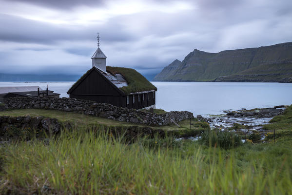 Cloudy sky on the historic church in Funningur, Eysturoy Island, Faroe islands