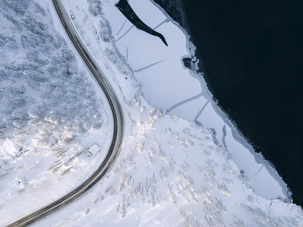 Aerial view of road around the frozen Lake Sils, Plaun da Lej, Maloja Region, Canton of Graubunden, Engadin, Switzerland