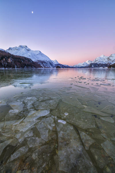 Sheets of ice on the surface of Lake Sils in a cold winter morning at dawn Upper Engadine Canton of Graubunden Switzerland 