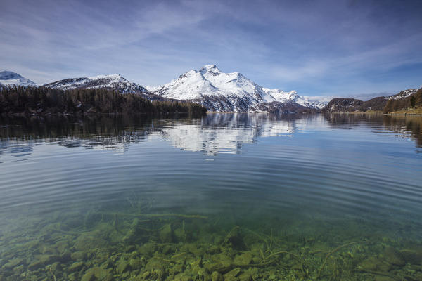 Piz da la Margna is reflected in the clear water of Lake Sils Maloja Pass Engadine Canton of Graubunden Switzerland 
