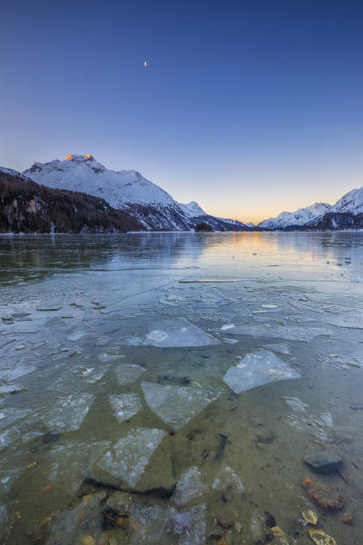 The snowy peaks are reflected at Lake Sils at dawn Upper Engadine Canton of Graubunden Switzerland 