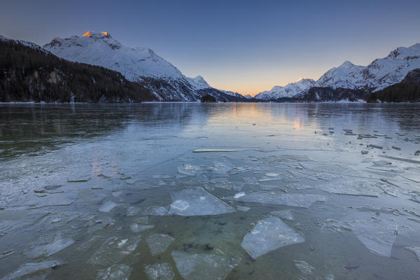 Sheets of ice on the surface of Lake Sils in a cold winter morning at dawn Upper Engadine Canton of Graubunden Switzerland 
