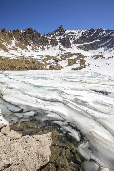 The snow begins to melt due to the spring thaw at Laj dal Teo Poschiavo Valley Canton of Graubunden Switzerland 