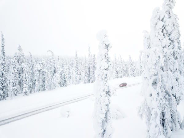 Elevated view of car on the icy road among frozen trees, Pallas-Yllastunturi National Park, Muonio, Lapland, Finland