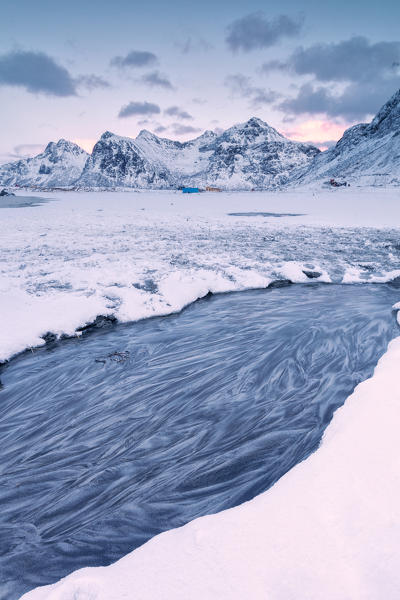 Frozen sea surrounded by snow, Skagsanden, Flakstad municipality, Lofoten Islands, Norway