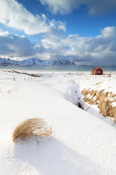 Snow surrounding the sandy beach, Ramberg, Flakstad municipality, Lofoten Islands, Norway