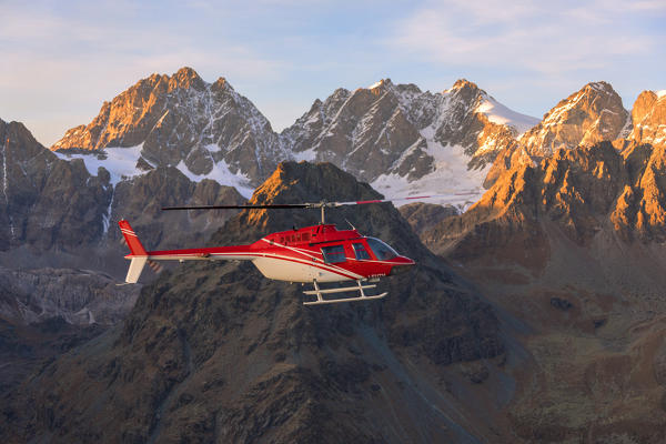 Aerial view of helicopter in flight on peaks of the Bernina Group, border of Italy and Switzerland