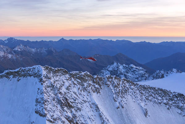 Aerial view of helicopter in flight on peaks of the Bernina Group, border of Italy and Switzerland