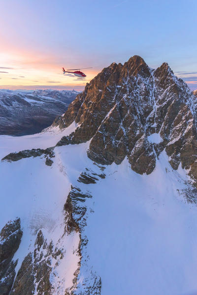 Aerial view of helicopter in flight towards Piz Roseg at sunset, Bernina Group, border of Italy and Switzerland