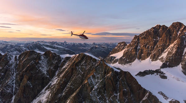 Aerial view of helicopter in flight towards Piz Roseg at sunset, Bernina Group, border of Italy and Switzerland