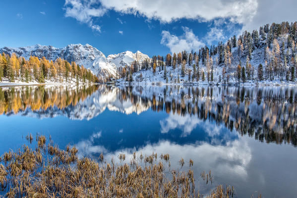 The still water of Lake Malghette reflecting the Brenta Dolomites peaks in autumn. Adamello Natural Park. Dolomites. Trentino Alto Adige. Italy. Europe
