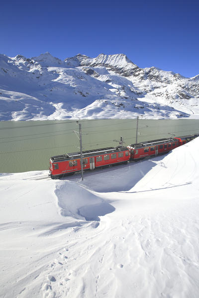 The Bernina Express (Unesco World Heritage) at the Bernina pass close to Lake Bianco - Bernina pass, Engadin, Canton Graubuenden, Switzerland Europe