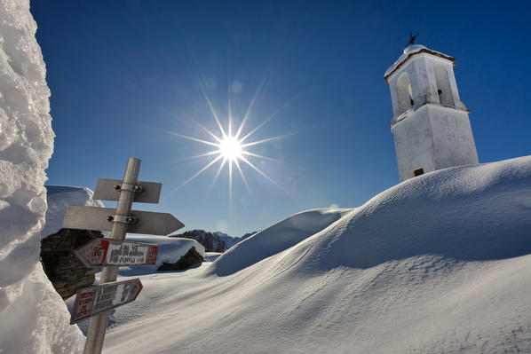 The bell tower at the Scima alp during the winter season. Sondrio. Valchiavenna Valtellina Lombardy. Italy. Europe