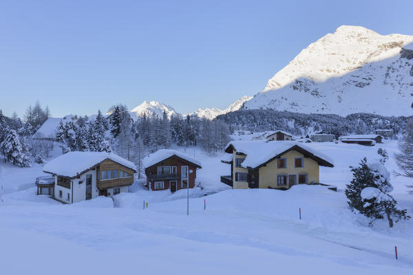 Houses surrounded by snow, Maloja Pass, Bregaglia Valley, Canton of Graubunden, Engadin, Switzerland